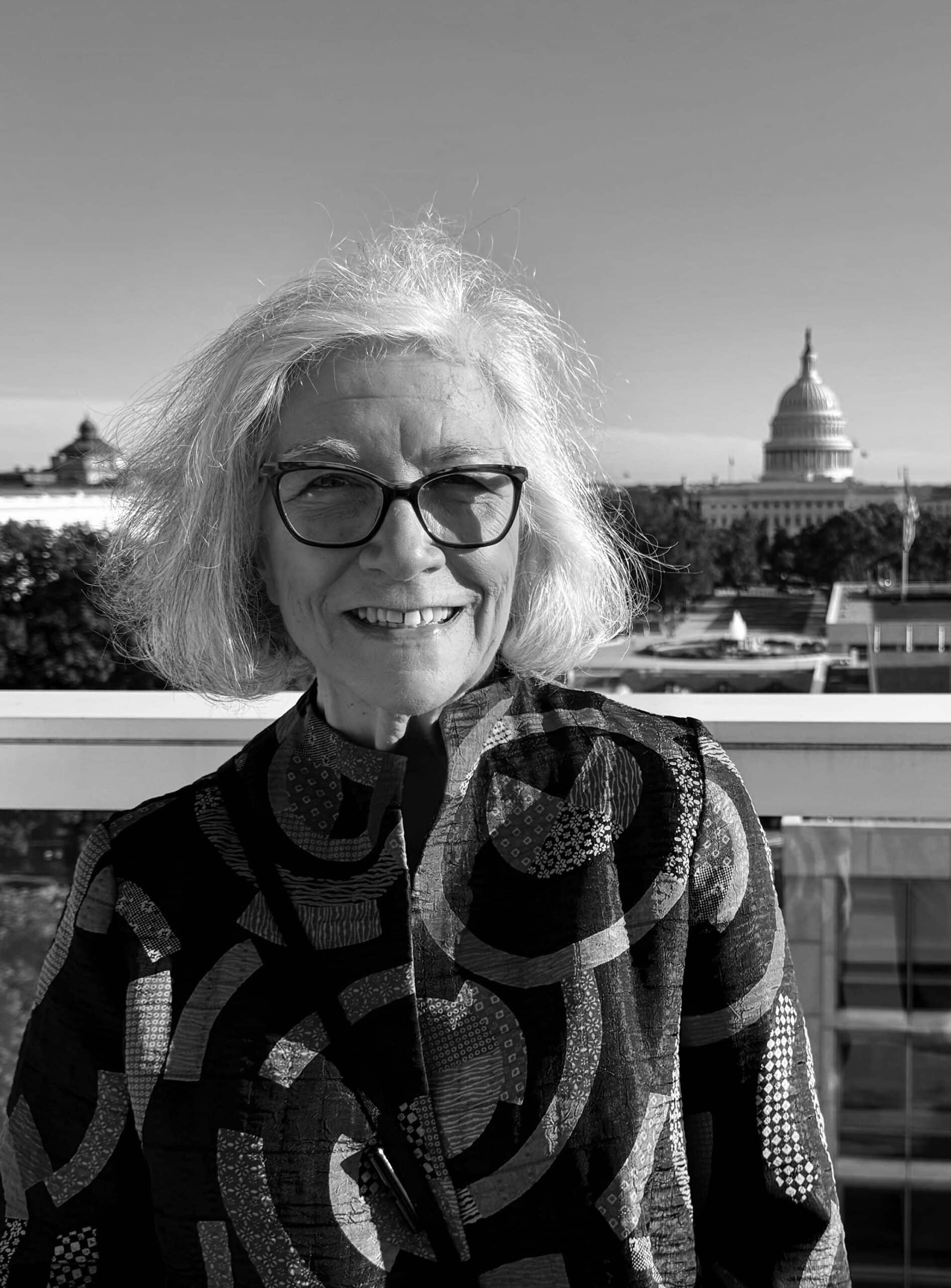 Female Person In Patterned Coat. Executive Director, Susan Mackert